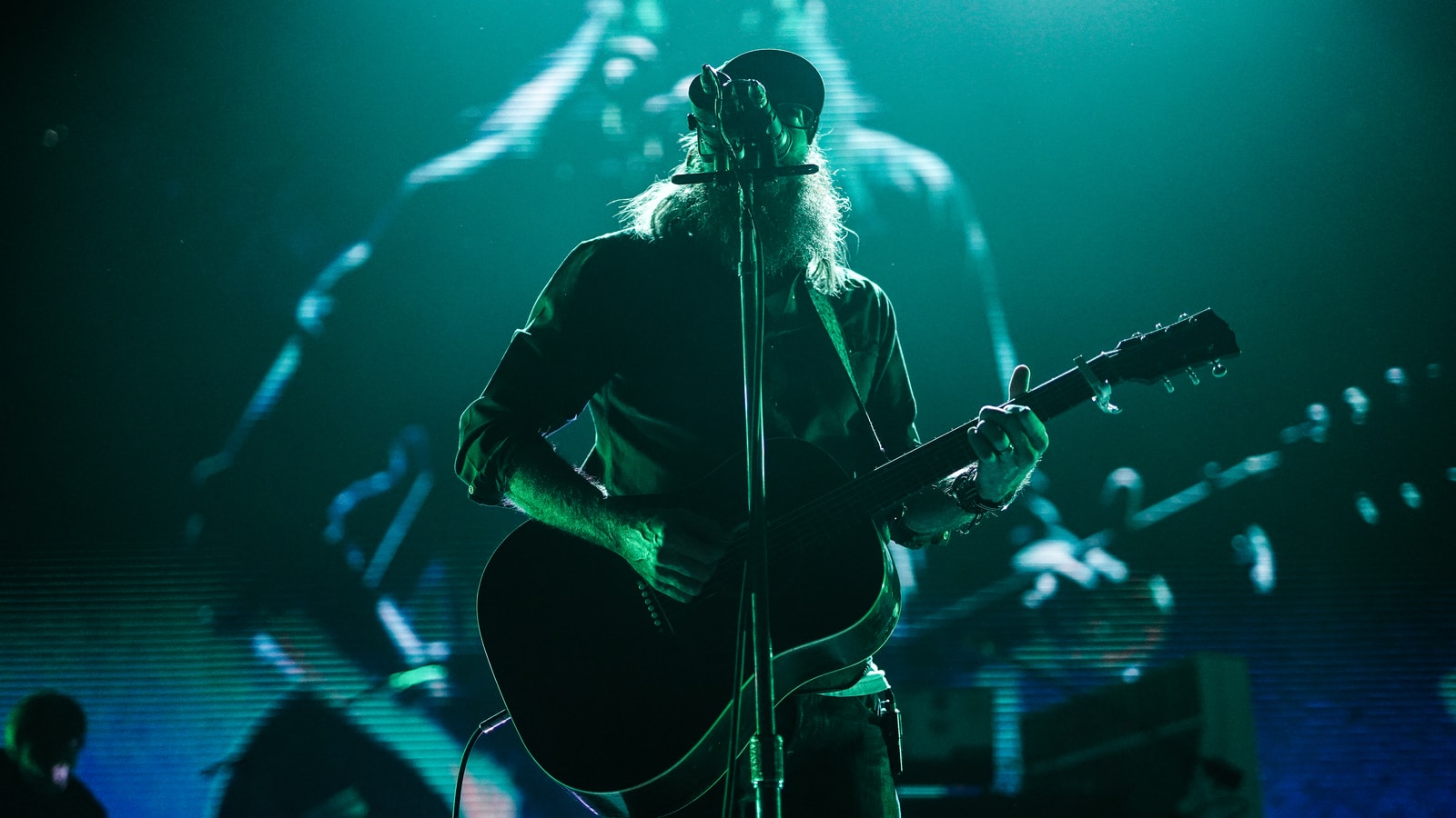 man playing guitar on stage